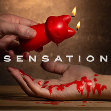 Load image into Gallery viewer, An image of a male&#39;s hand holding a lit up blush Temptasia Fox Drip Candle, and dripping its wax on top of a female&#39;s palm. In the middle is a caption text: Sensation.