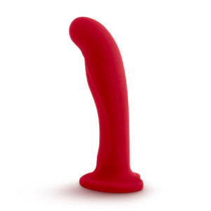 Side view of the blush Temptasia Jezebel Dildo, standing on its suction cup base.