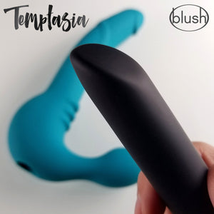 Close up of the bullet vibrator, and the Strapless Dildo laying in the background. On the top are the Temptasia, and blush logos.