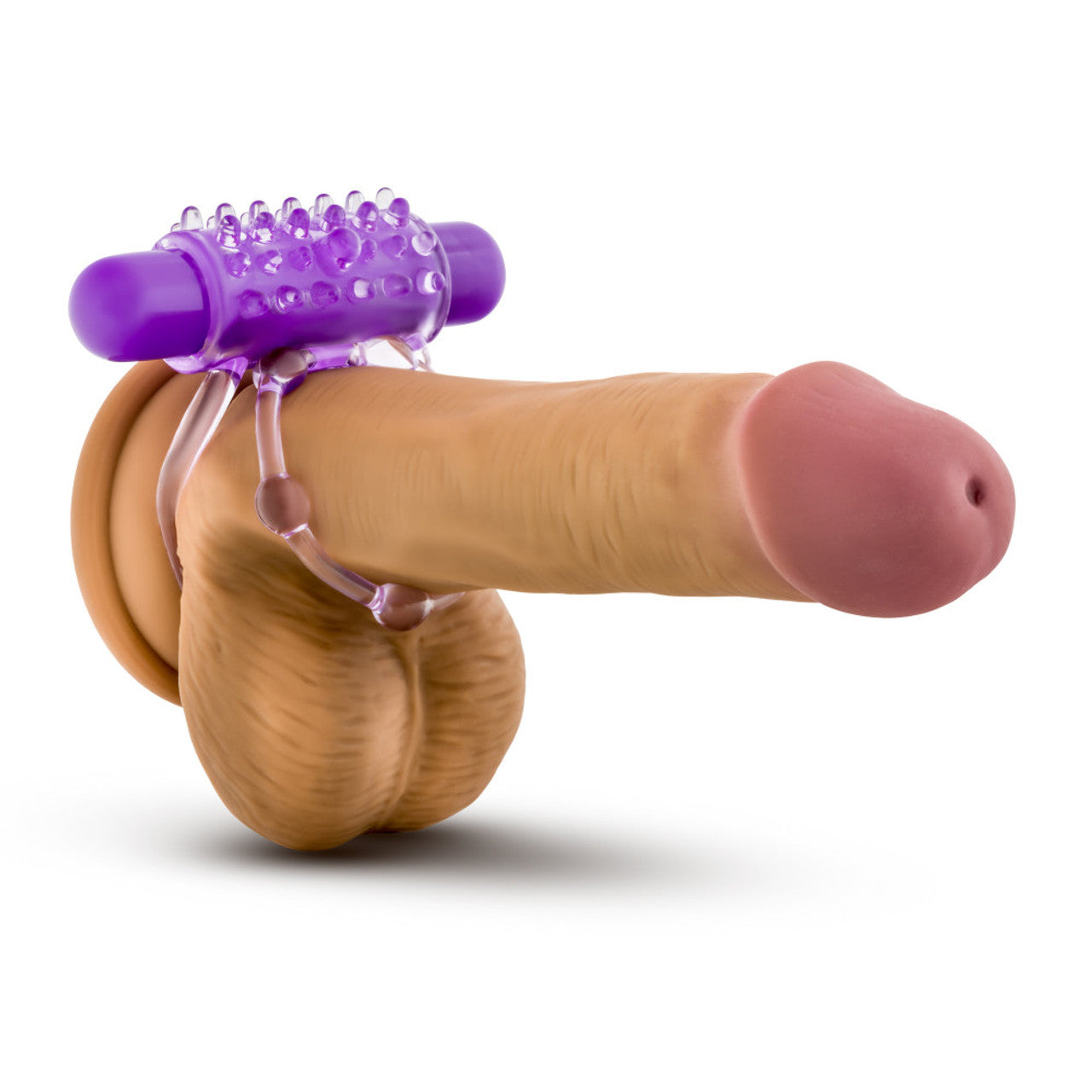 Front side view of a realistic dildo, with the blush Play with Me The Player Vibrating Double Strap Cock Ring harnessed on top, showing how the product should be worn.