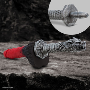 An image of the blush The Realm Rougarou Locked on the Lycan Warewolf Dildo, laying on a rocky surface. In the top right is a close up of the Lock On part of the handle, and in the bottom left "Dildo not included".