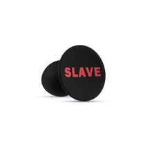 Load image into Gallery viewer, Bottom side view of the blush Temptasia Slave Plug, with the word &quot;slave&quot; written at the bottom of the base.