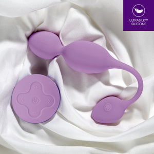 blush Wellness Raine Vibrating Kegel Ball laying on white fabric. In the top right corner is a feature icon for Ultrasilk Silicone.