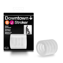 Load image into Gallery viewer, On the left side of the image is the product packaging. On the product packaging displayed Downtown BJ Stroker (product name), product features: Head Enhancer; Glows in the Dark; Ribbed for Pleasure, on the right side is an illustration of two stick figures, one give a BJ to another, bottom left is the blush logo, and in the lower middle is the product visible through the clear packaging. Beside the packaging is the product, laying on its side.