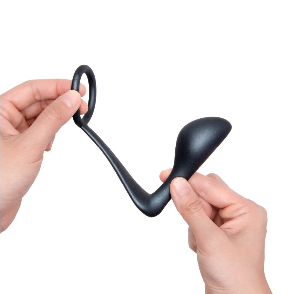 Two hands holding the b-Vibe Butties Ringer Cock RIng & Prostate Plug, the left hand is holding the cock ring part, and the right hand is holding the plug.