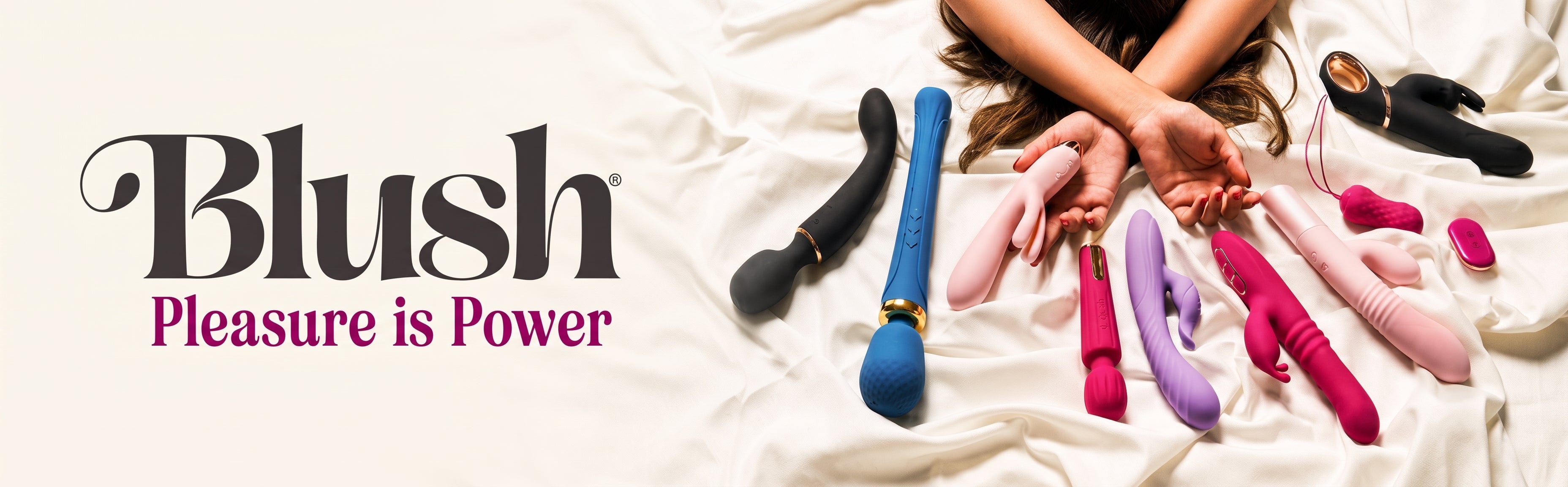 A promotional banner for Blush showing multiple personal massagers in pink, purple, blue, and black arranged on white satin bedding, with a person's hands and arms visible holding some of the devices. The Blush logo and the slogan 'Pleasure is Power' appear on the left.