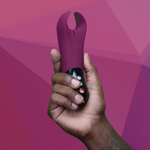 Fun Factory Jewels MANTA Limited Edition Penis Toy being held by a male hand, showing the size scale of the product.