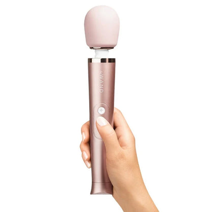 Le Wand Petite Rose Gold Massager being held showing the size scale of the product compared to a human hand