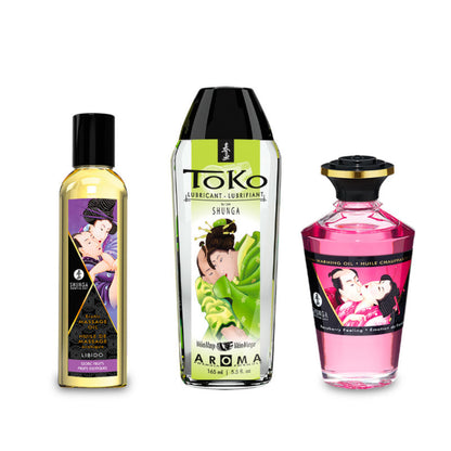 The three full-size products from the SHUNGA Fruity Kisses collection: Libido Massage Oil, Toko Aroma Lubricant, and Raspberry Warming Oil.