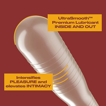 A close-up view focusing on the clear, bulbous tip of a ribbed latex condom against a deep red background. Yellow text boxes point to the product features, reading "UltraSmooth Premium Lubricant INSIDE AND OUT" and "Intensifies PLEASURE and elevates INTIMACY", showcasing the specialized texture and lubrication design.