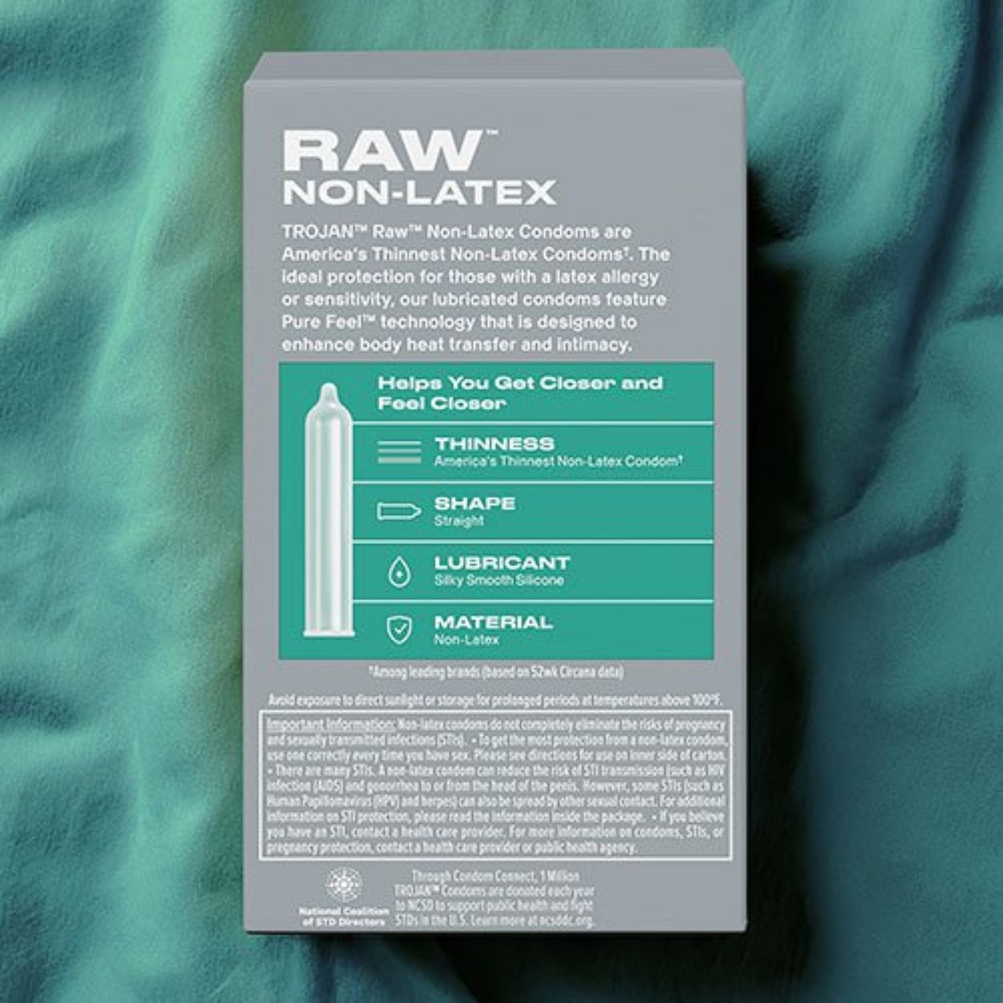 Back of Trojan Raw Non-Latex Condoms grey package, displaying a teal feature chart highlighting an ultra-thin profile, straight shape, silicone lubricant, and polyurethane material.