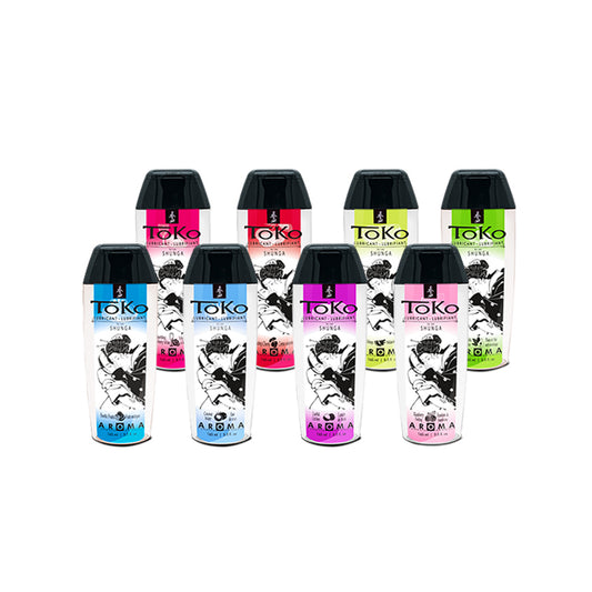 A collection of eight different TOKO Aroma flavoured lubricants by Shunga, showcasing a variety of colourful labels and flavours.