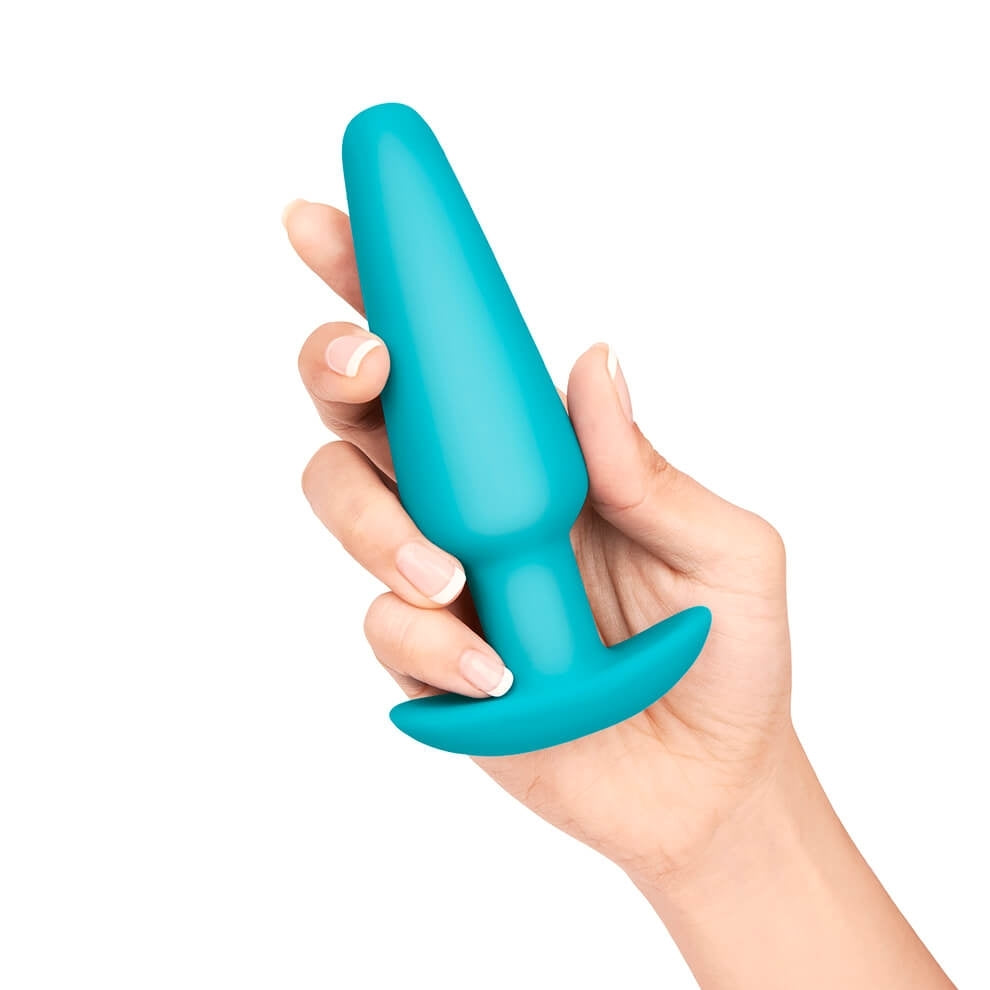 An image of the Large Weighted Butt Plug held, showing the size scale of the product