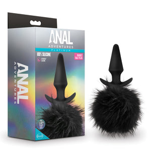 An image of a package on the left, and on the right is the product blush Anal Adventures Platinum Rabbit Tail Plug. On the left side of the package is written Anal Adventures. On the front of the package is written Anal Adventures Platinum 100% silicone Ultrasilk silicone Rabbit Tail Plug, in the centre middle is the product, and on the bottom left Plug 1.5" Width, and blush logo.