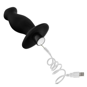blush Anal Adventures Platinum Vibrating Prostate Massager 2 with a charging cable connecting to the charging port at the back of the product, underneath the power button.