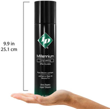 Load image into Gallery viewer, Size guide for ID Millennium Long Lasting Pure Silicone Lubricant Ultra Slippery 17 fl. oz. (500 ml) compared to a human hand. The height of the bottle is 9.9 inches or 25.1 centimetres.