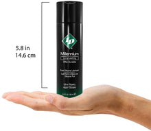 Load image into Gallery viewer, Size comparison for ID Millennium Long Lasting Pure Silicone Lubricant Ultra Slippery 4.4 fl. oz. (130 ml) compared to a human hand. The hight of the bottle is 5.8 inches or 14.6 centimetres.