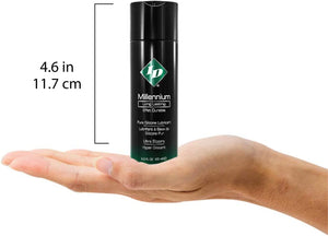 Size guide for ID Millennium Long Lasting Pure Silicone Lubricant Ultra Slippery 1 fl. oz. (30 ml) compared to a human hand. The height of the bottle is 4.6 inches or 11.7 centimetres.
