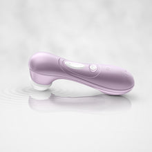 Charger l&#39;image dans la galerie, The Satisfyer Pro 2 Air Pulse Stimulator Laying on it&#39;s head in some water, the water waves ripple from the head of the product showing the air pulse waves from the product. On the back of the handle are the controls.