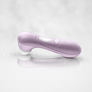 The Satisfyer Pro 2 Air Pulse Stimulator Laying on it's head in some water, the water waves ripple from the head of the product showing the air pulse waves from the product. On the back of the handle are the controls.