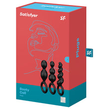 Load image into Gallery viewer, Satisfyer Booty Call Plugs Black variant. Contains three black plugs, 15 year guarantee. On the side of the package written Plugs, with a &quot;sf&quot; logo tag.