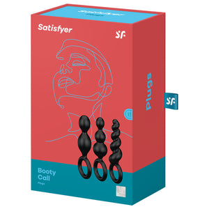 Satisfyer Booty Call Plugs Black variant. Contains three black plugs, 15 year guarantee. On the side of the package written Plugs, with a "sf" logo tag.