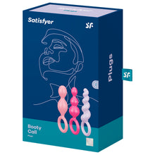 Load image into Gallery viewer, Front package of Satisfyer Booty Call Plugs Coloured variant. Contains one light pink plug, one pink plug, and one light purple plug, 15 year guarantee. On the side of the package written Plugs, with a &quot;sf&quot; logo tag.