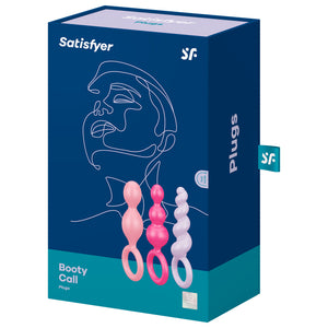 Front package of Satisfyer Booty Call Plugs Coloured variant. Contains one light pink plug, one pink plug, and one light purple plug, 15 year guarantee. On the side of the package written Plugs, with a "sf" logo tag.
