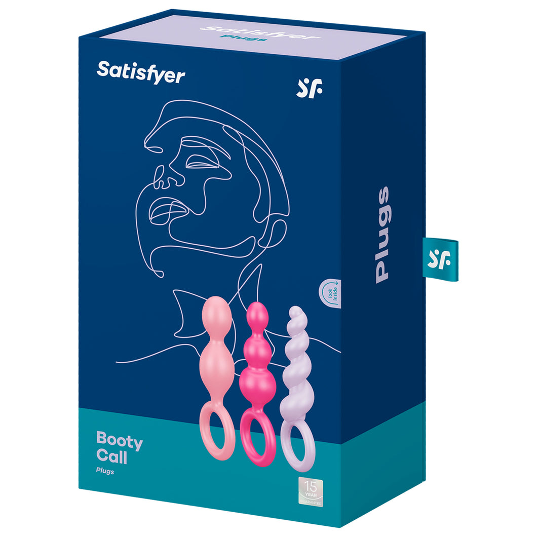 Front package of Satisfyer Booty Call Plugs Coloured variant. Contains one light pink plug, one pink plug, and one light purple plug, 15 year guarantee. On the side of the package written Plugs, with a 