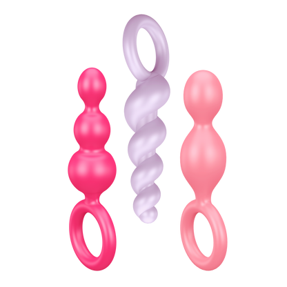 Satisfyer Booty Call Plugs coloured variant. One pink plug, upside down light purple plug, and a light pink plug.