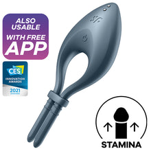 Load image into Gallery viewer, Also Usable with free app. CES Innovation Awards 2021 Honoree. Satisfyer Bullseye Ring Vibrator Product top view showing adjustable straps, controls and the charging port, with &quot;sf&quot; logo. Icon for stamina.