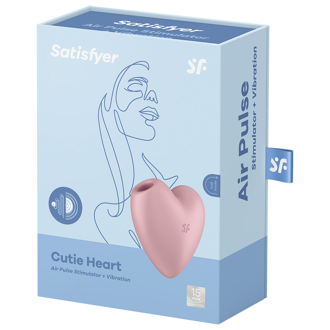 Front of the Satisfyer Cutie Heart Air Pulse Stimulator + Vibration. Pink front left side view of the product, and 15 year guarantee. On the side of the package is written Air Pulse Stimulator + Vibration, and a tag with a 