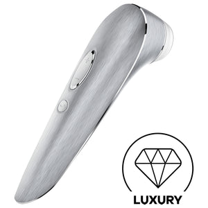 Back side of the Satisfyer High Fashion Luxury Air Pulse Stimulator + Vibration with the controls visible  on the handle marked by + - and a wave button. On the bottom right is a diamond icon for Luxury.
