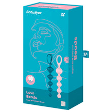 Load image into Gallery viewer, Front of the package for Satisfyer Love Beads Super Soft Silicone Beads, on the right side are dark blue, and light pink super soft silicone beads, vertically placed with the tip pointing down. On the right side of the package is written Super Soft Silicone Beads, and a tag sticking out from the back with the SF logo on it.