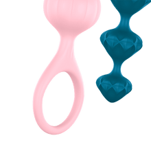 Load image into Gallery viewer, Close up of the Pink Satisfyer Love Bead showing the wrist strap, and on the right is the tip of the dark blue Satisfyer Love Bead.