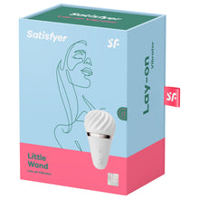 Load image into Gallery viewer, Front of the package for Satisfyer Little Wand Lay-on Vibrator, on the top are the Satisfyer logos, on the right side is the lay-on vibrator, with the controls visible on the product, and on the bottom right is the 15 Year Guarantee. On the right side of the package is written Lay-On Vibrator, and a tag with the SF logo sticking out from the back.