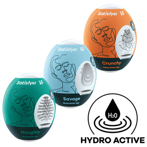 Three Satisfyer Masturbator Eggs top to bottom is orange Crunchy, light blue Savage, and green Naughty. On the bottom right is an icon with an H2O drop indicating Hydro Active.