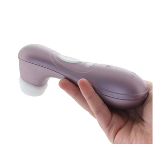 The Satisfyer Pro 2 Air Pulse Stimulator being held from the front, with the controls visible on top of the product, showing the scale size of the product.
