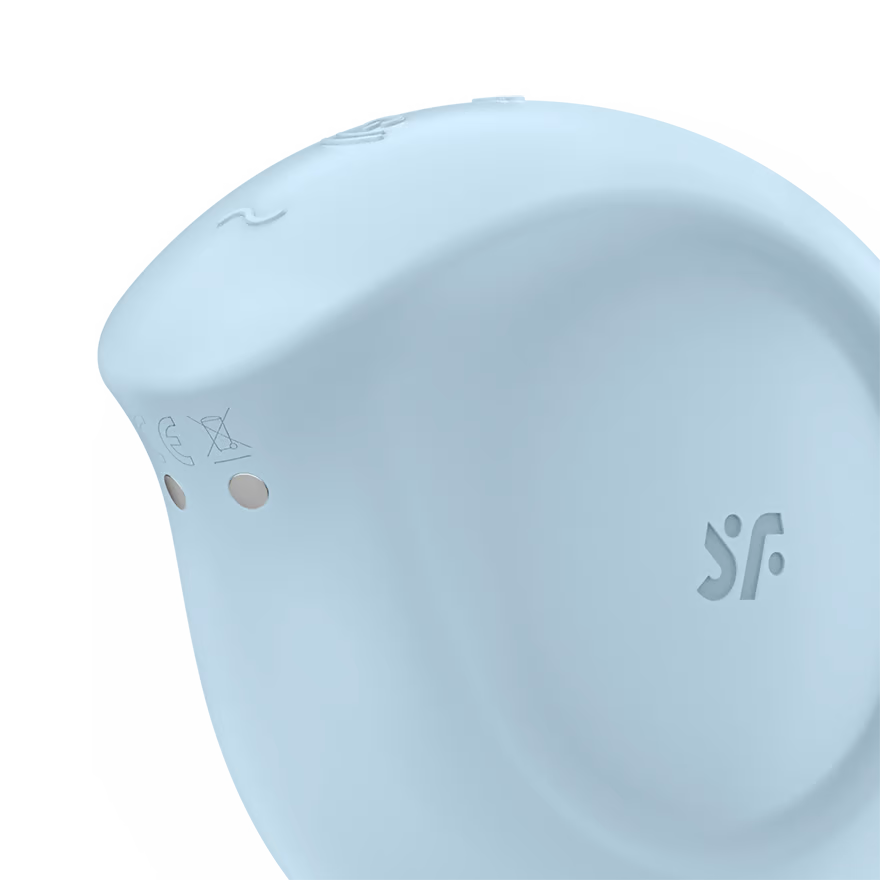 Close up of the upper back side of the Satisfyer Sugar Rush Air Pulse Stimulator, on the top are the controls partially visible, on the side of the product is the engraved SF logo, and on the upper back is the charging port.