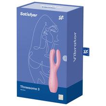 Load image into Gallery viewer, Front of the package from the top are the Satisfyer logos, on the bottomleft is the product name Threesome 3 Vibrator, on the right side is the product facing front left, with partial controls visible on the left side of the product, and on the bottom right is a mark for 15 year guarantee. On the right side of the package is written Vibrator, and from the back is a tag sticking out with the SF logo.
