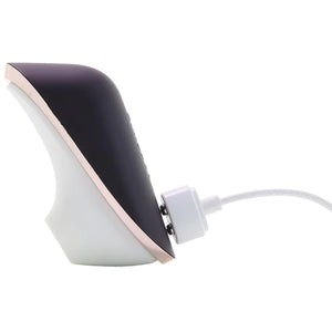 Side view of the Satisfyer Traveler Air Pulse Stimulator, plugged in to the charging port with the charging cable.